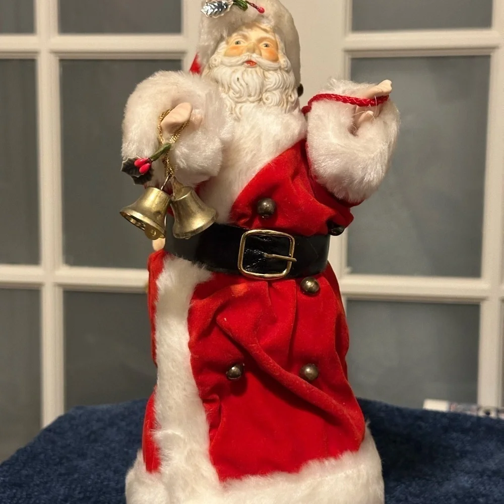 Beautiful Santa hugs 2 small children and plays Santa Claus is Coming to Town.